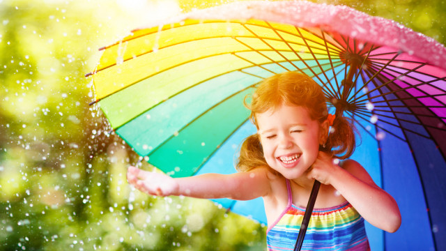 девочка под зонтом радуется дождь
